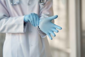 Elective Procedures Doctor Putting On Gloves